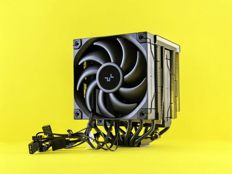 A sleek and modern CPU cooler with cables displayed against a vibrant yellow backdrop.