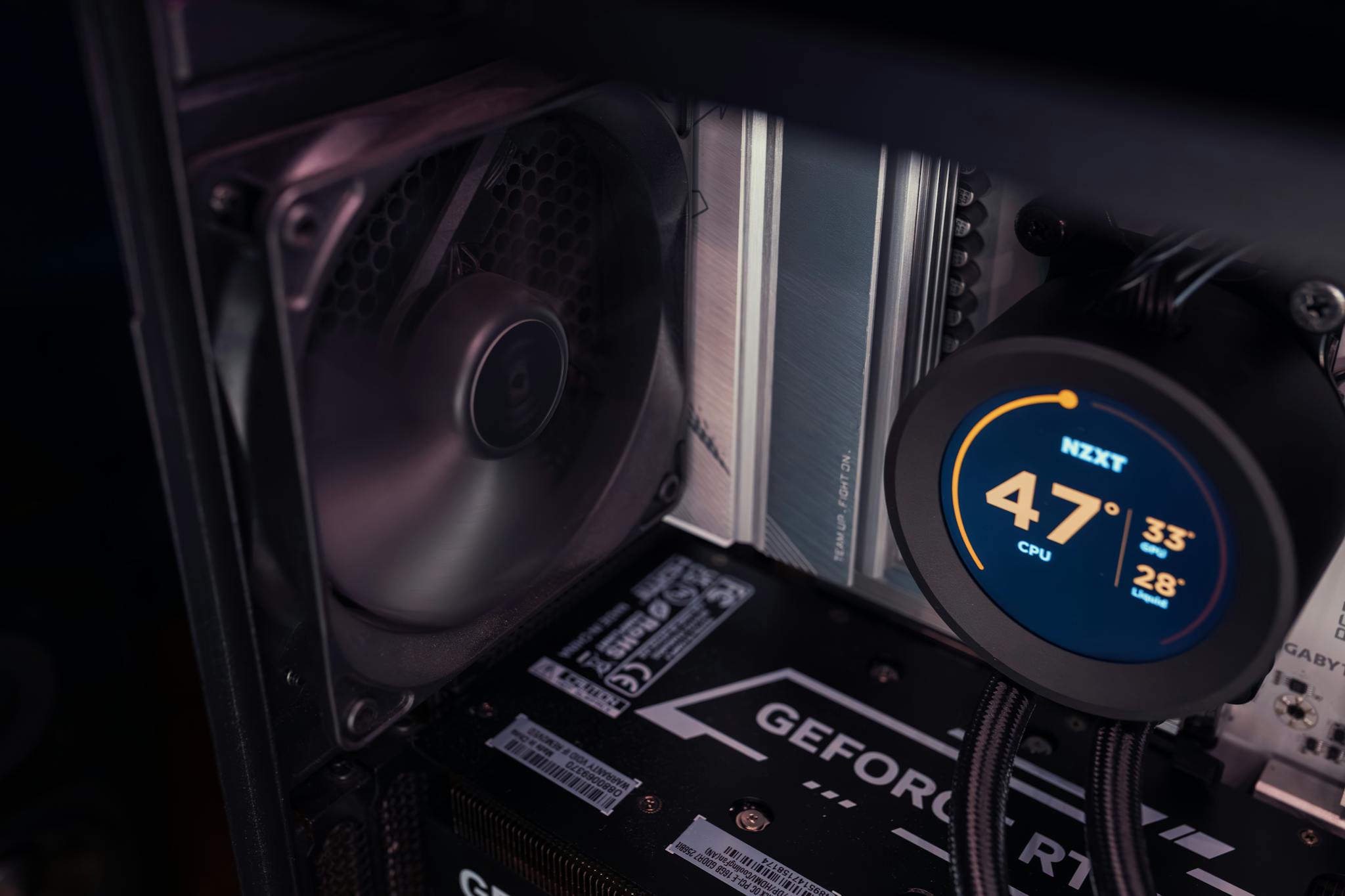 Detailed view of a gaming PC's internal cooling system with visible temperature readout.